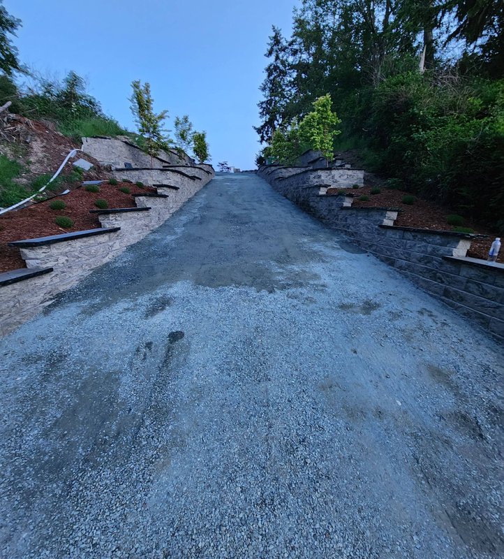 Hillside driveway with stepped stone retaining walls in Oak Harbor