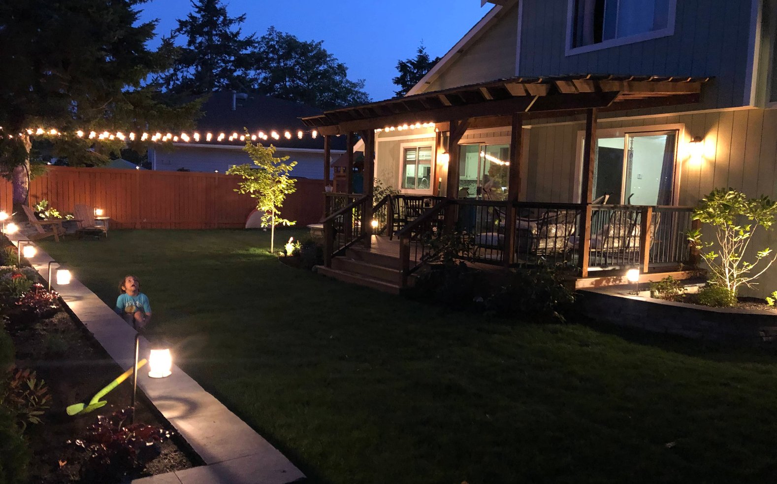 Landscape lighting on a deck and garden at dusk in Oak Harbor