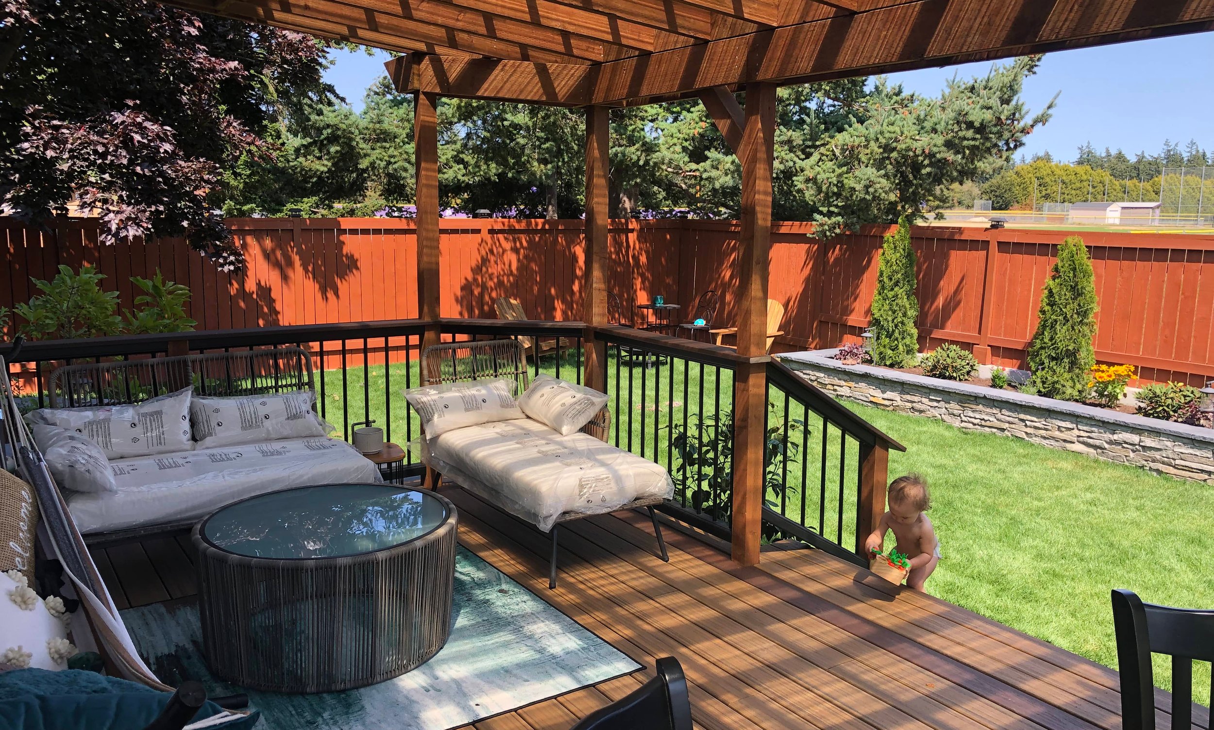Wooden deck and pergola overlooking a landscaped lawn in Oak Harbor