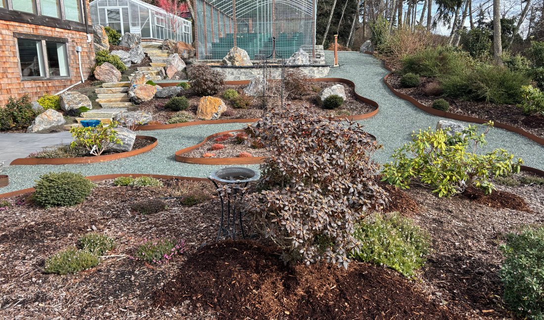 Terraced hillside garden with gravel paths on Whidbey Island