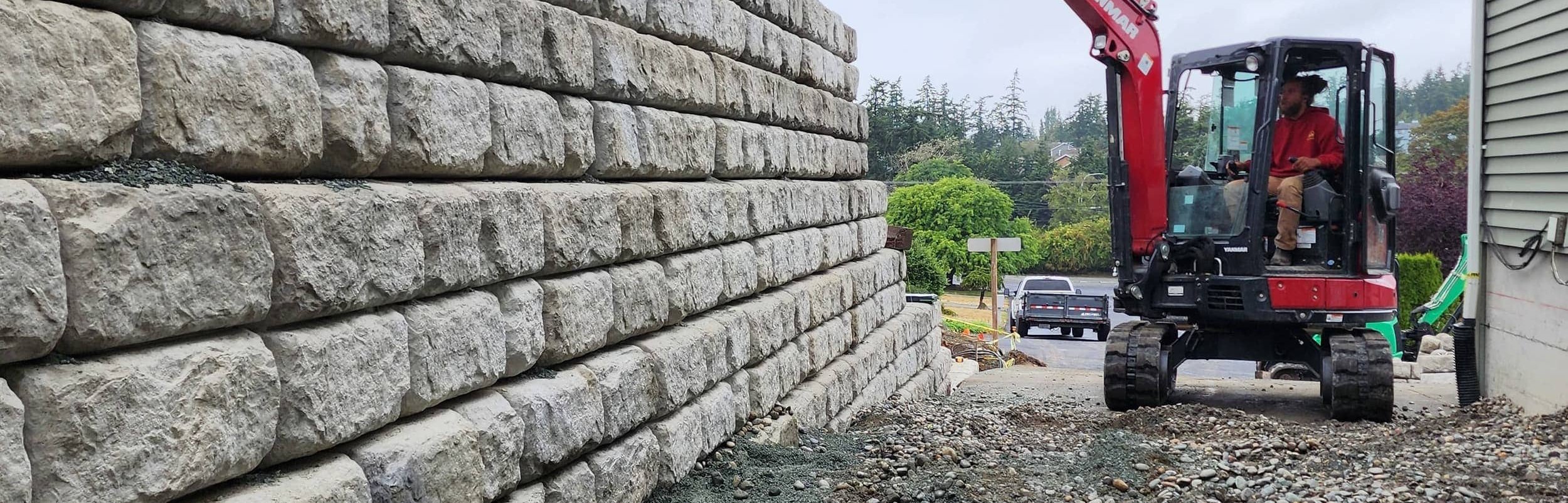 Crew installing a tiered block retaining wall on Whidbey Island