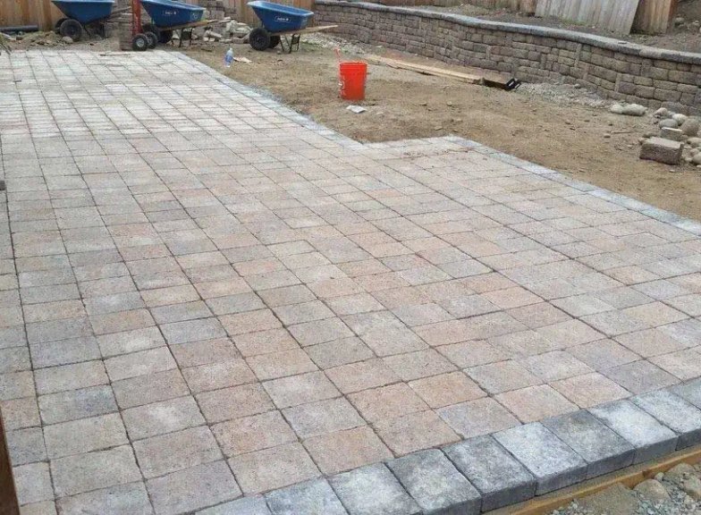 Paver patio with charcoal border being installed in Oak Harbor