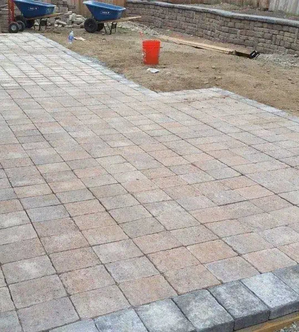 Paver patio with charcoal border being installed in Oak Harbor
