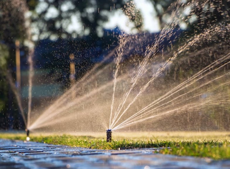 Pop-up sprinkler watering a lawn in Oak Harbor